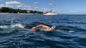 Swimmer at Bellevue Strand Beach in clear blue water
